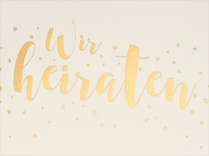 Vergrößerte Abbildung Detailaufnahme der goldenen Schrift und der Konfettis.