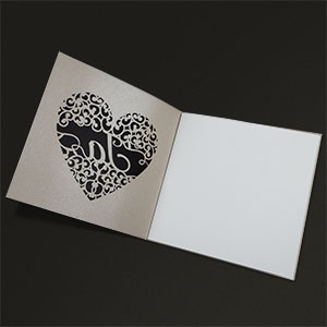 Vergrößerte Abbildung Filigran ausgeschnittenes Herz vor schwarzem Hintergrund